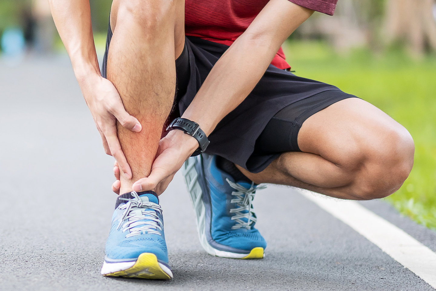 Young adult male with his muscle pain during running. runner man having leg ache due to Shin Splints. Sports injuries and medical concept