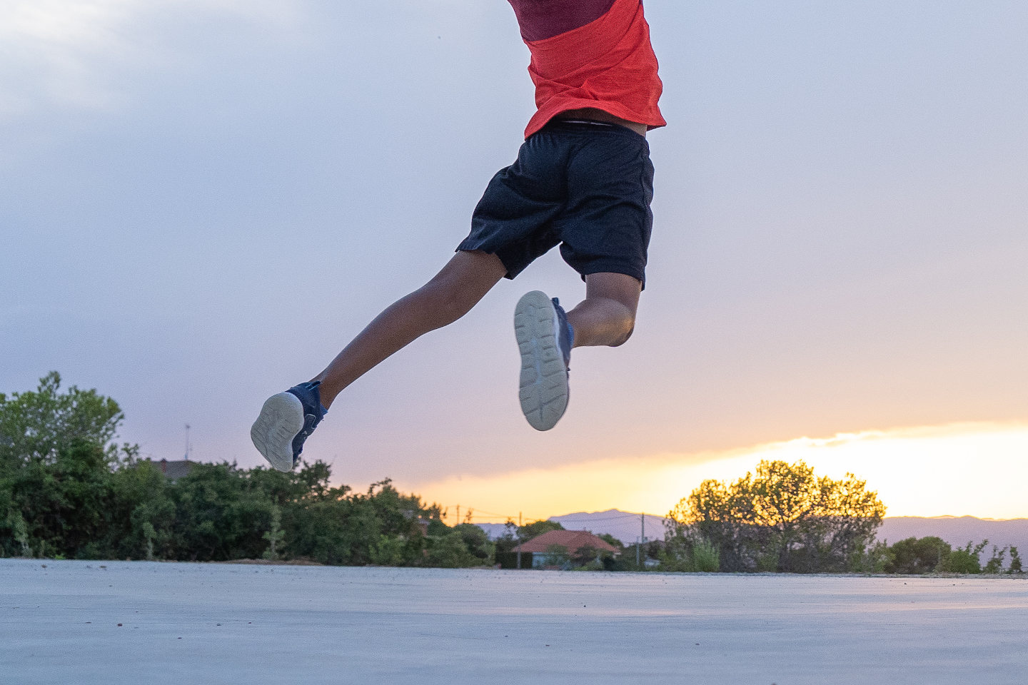 Boy throwing a ball in a basket on a basketball court