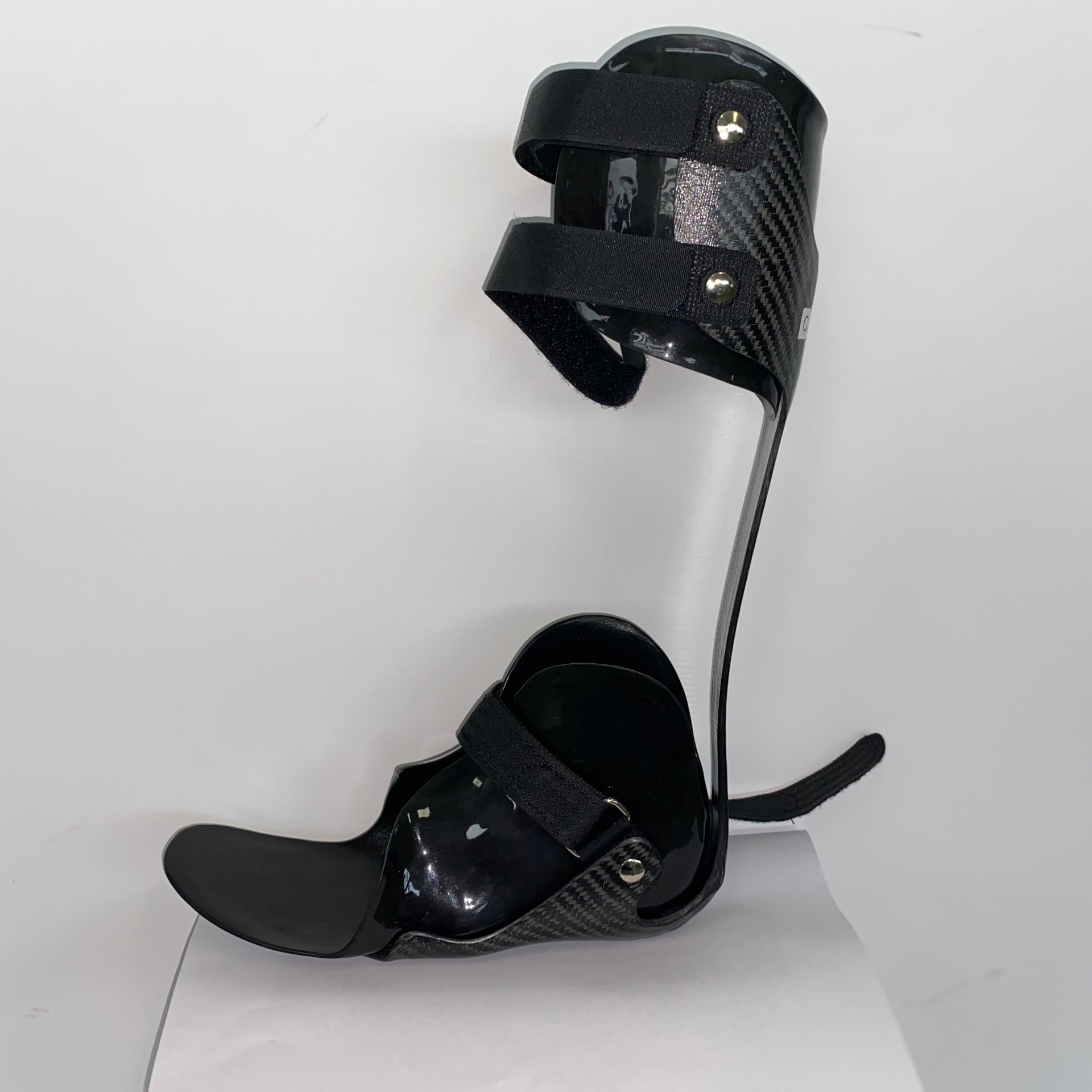 The custom ankle-foot orthosis is a brace, made of rigid carbon