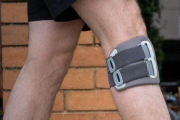 Person walking with a functional electrical stimulation (FES) cuff fitted below the knee